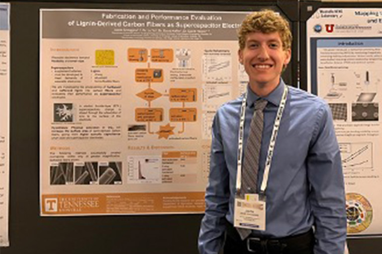 Jakob Scroggins’ poses next his award-winning poster at the Functional Materials Division Undergraduate Poster Competition. 